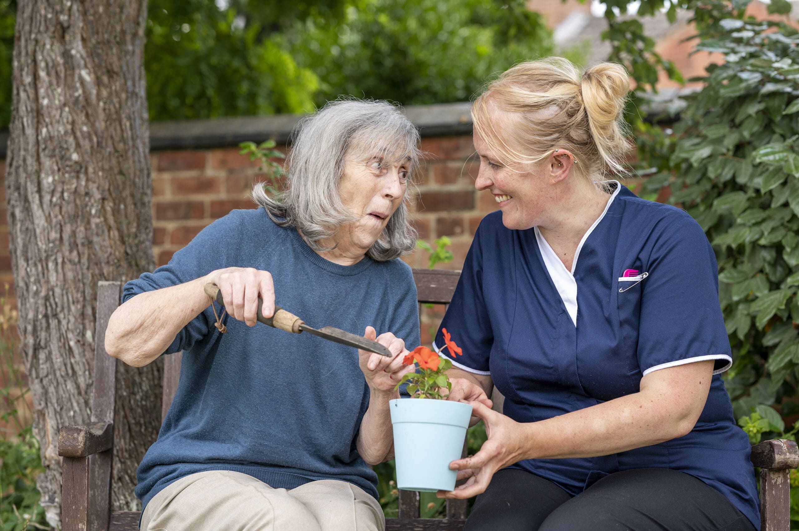 Horticulture Therapy for Residents | Our resident planting flowers with our team member