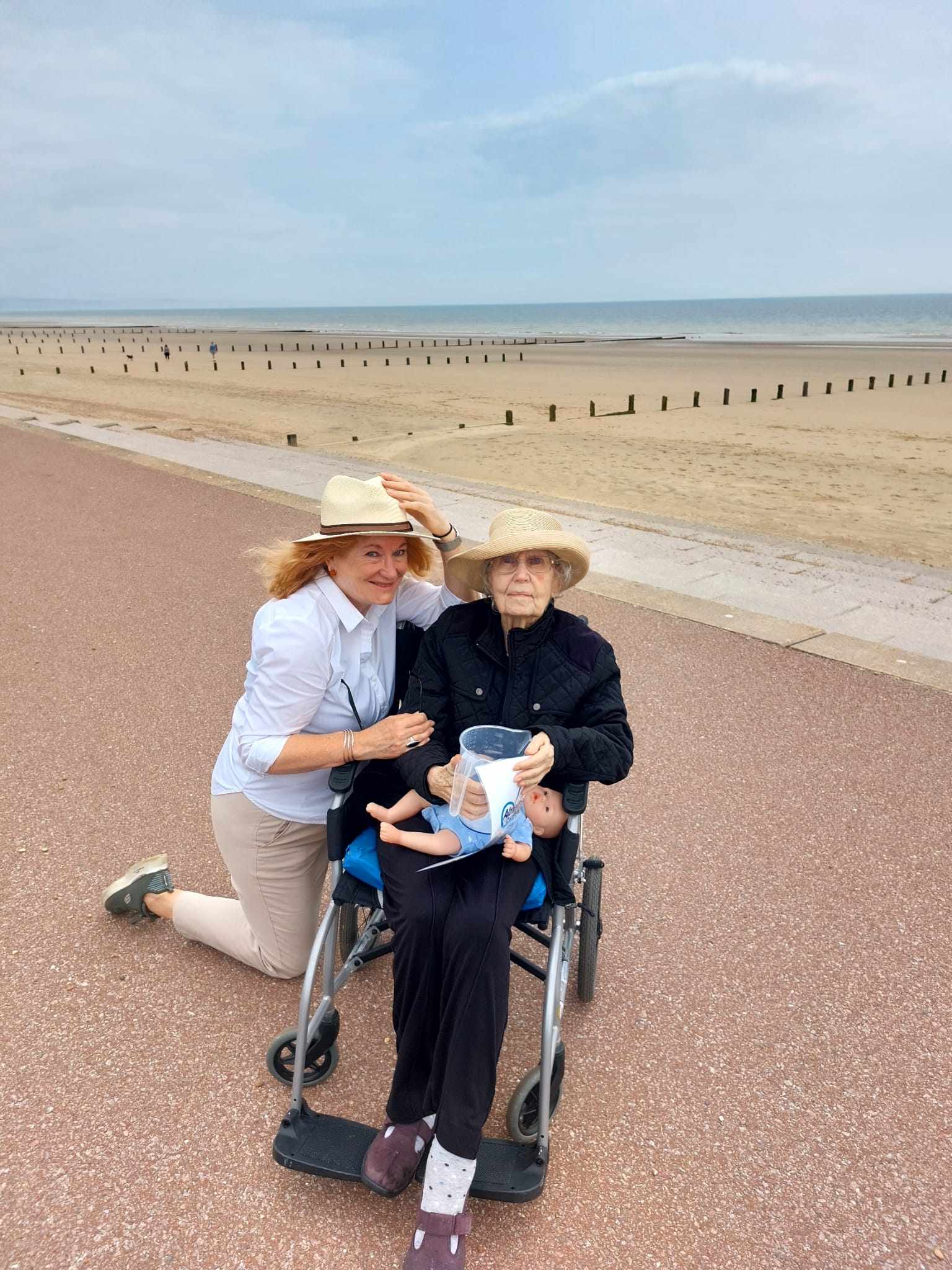 Fundraising for Alzheimer's | Team member and resident holding a bucket for fundraising