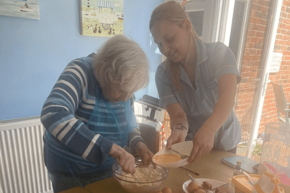 Resident carer baking muffins