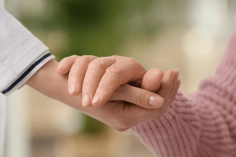 Carer and Resident Embracing, Holding Hands